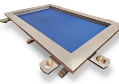 Custom Canadian hardwood board game table with blue recessed gaming surface and cupholders on a hidden robust steel track system.