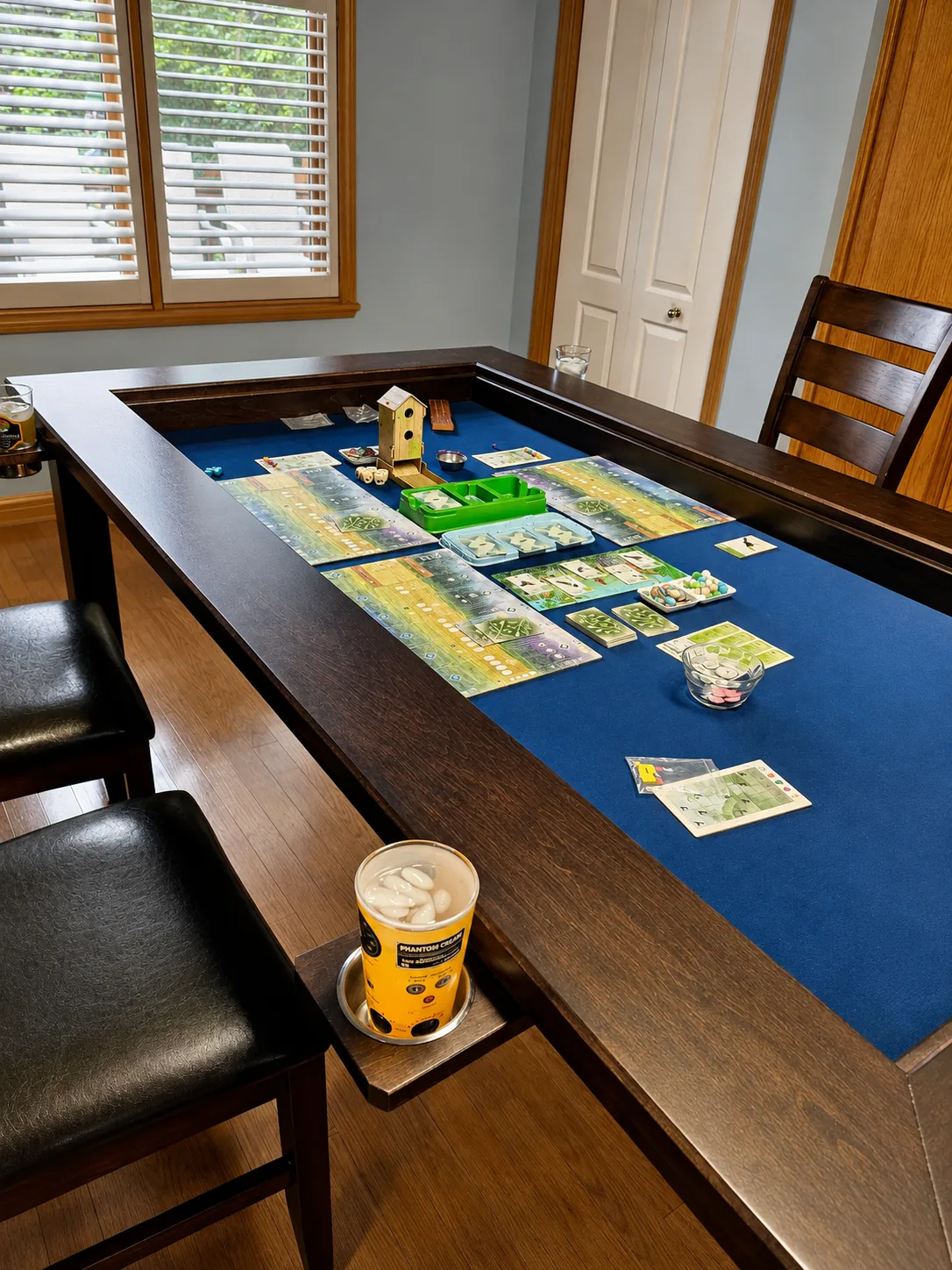 Board Game Table with Wingspan Game in Progress - Western Pride Woodworks Wingspan board game set up inside a dark stained hard maple gaming table with a blue neoprene surface.