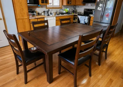 Dark Stained Maple Board Game Table in Client Home - Western Pride Woodworks Dark stained hard maple board game table with matching dining chairs in a client’s home.